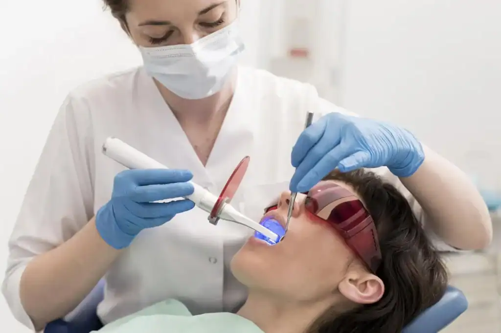Female patient undergoing advanced zoom Laser Teeth Whitening session with dental specialist Leicester